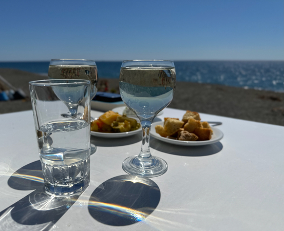 Two glasses of wine and snacks at the beach