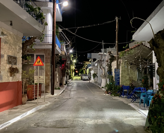 The quiet village street with taverns in the evening